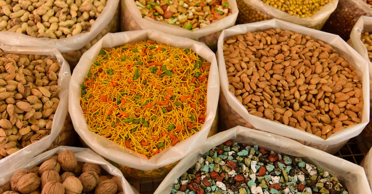 Variety of nuts and spices displayed in bags, showcasing colorful and diverse food options.